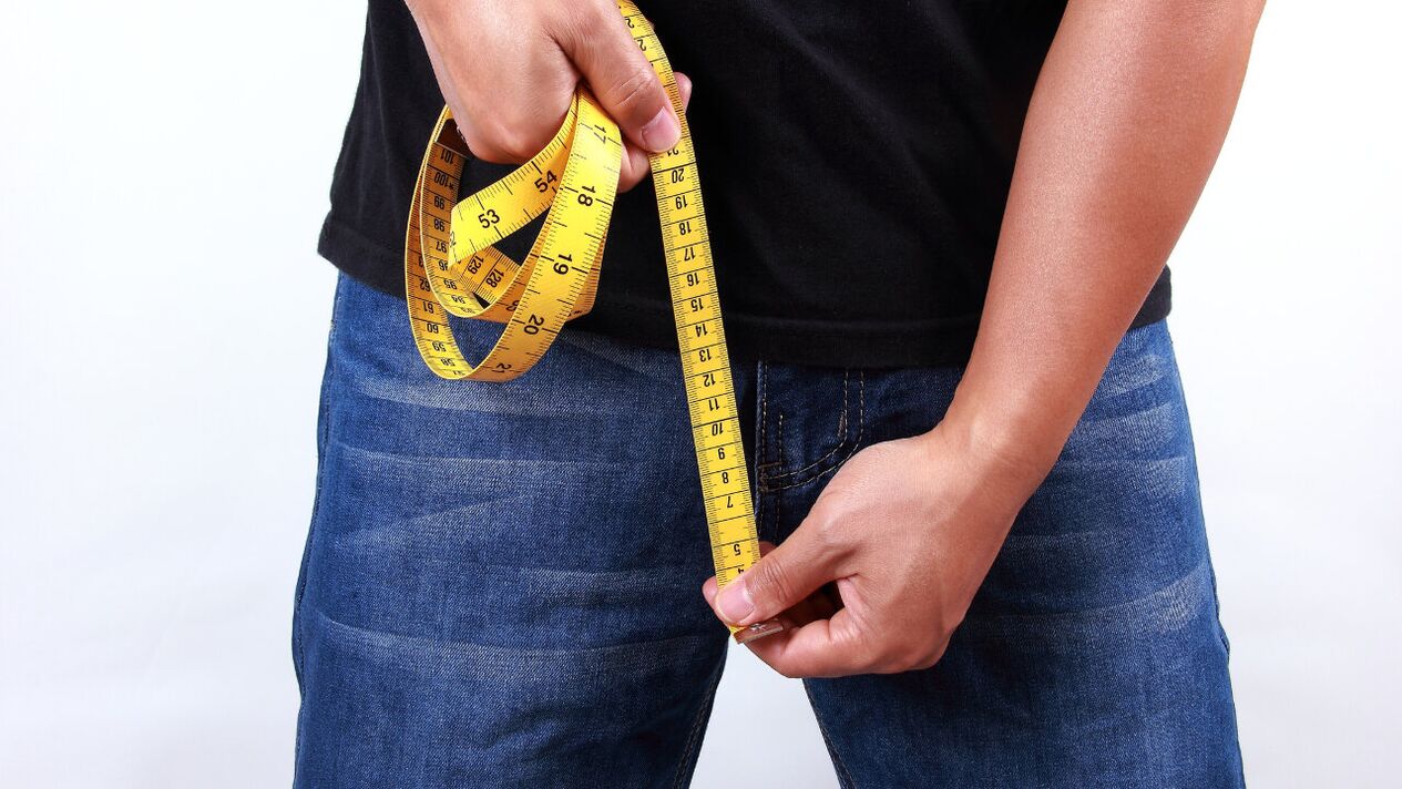 man measuring penis before enlargement