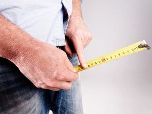 the man measures the length of the penis before enlarging it with soda